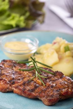 grilled pork steak with potato salad