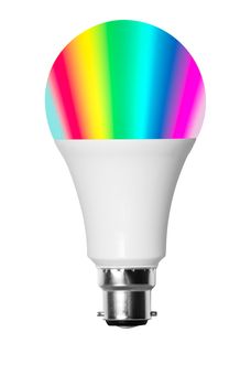 Isolated cutout smart LED bulb showing rainbow of colors with UK B22 bayonet fitting and set against white background