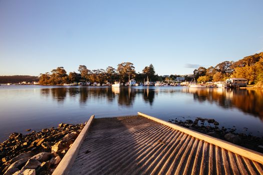 The idyllic setting across Wagonga Inlet at sunset in Narooma, NSW, Australia