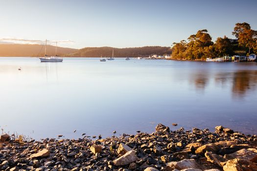 The idyllic setting across Wagonga Inlet at sunset in Narooma, NSW, Australia