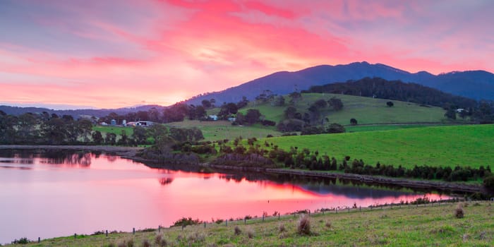 The idyllic setting across farmland at Mt Dromedary at sunset in Tilba, NSW, Australia