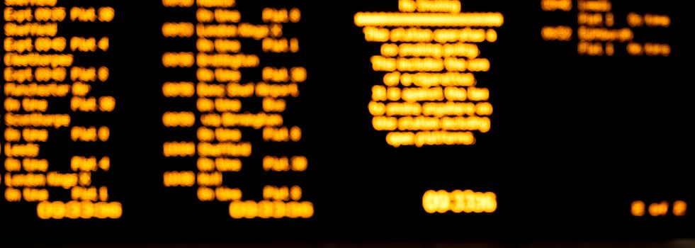 blurred led train schedule text on black background