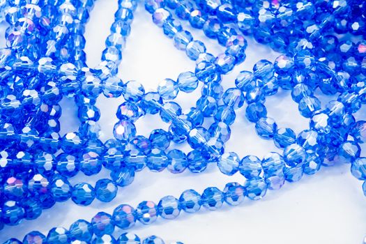 Beautiful blue Glass Sparkle Crystal Isoalted Beads on white background. Use for diy beaded jewelry. Space for text