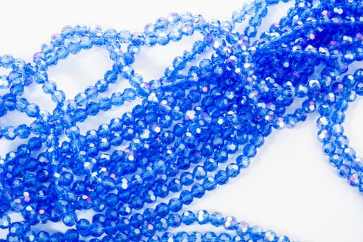 Beautiful blue Glass Sparkle Crystal Isoalted Beads on white background. Use for diy beaded jewelry. Space for text