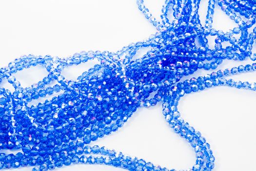 Beautiful blue Glass Sparkle Crystal Isoalted Beads on white background. Use for diy beaded jewelry. Space for text