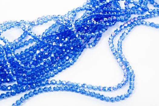 Beautiful blue Glass Sparkle Crystal Isoalted Beads on white background. Use for diy beaded jewelry. Space for text