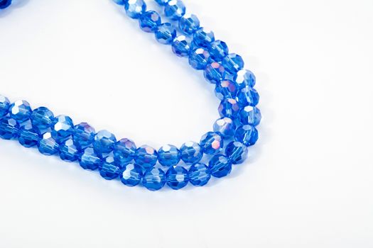 Beautiful blue Glass Sparkle Crystal Isoalted Beads on white background. Use for diy beaded jewelry. Space for text