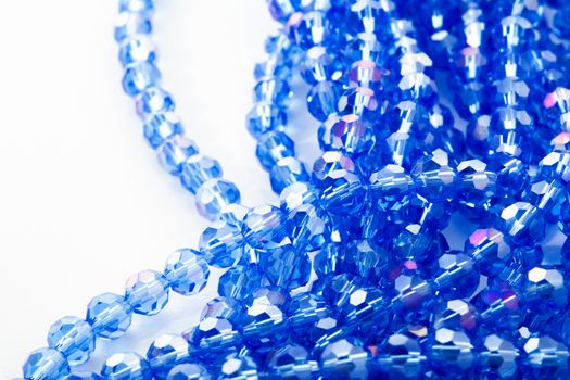 Beautiful blue Glass Sparkle Crystal Isoalted Beads on white background. Use for diy beaded jewelry. Space for text
