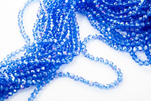 Beautiful blue Glass Sparkle Crystal Isoalted Beads on white background. Use for diy beaded jewelry. Space for text