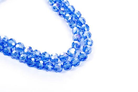 Beautiful blue Glass Sparkle Crystal Isoalted Beads on white background. Use for diy beaded jewelry. Space for text