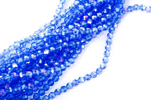 Beautiful blue Glass Sparkle Crystal Isoalted Beads on white background. Use for diy beaded jewelry. Space for text