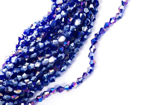Beautiful blue Glass Sparkle Crystal Isoalted Beads on white background. Use for diy beaded jewelry. Space for text