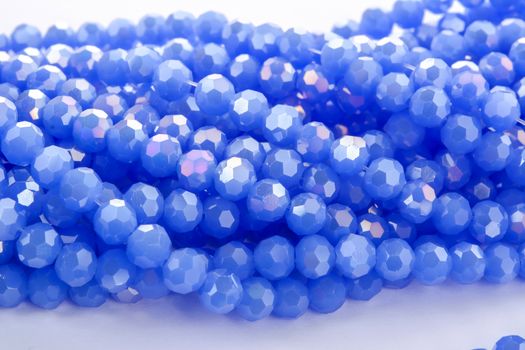 Beautiful blue Glass Sparkle Crystal Isoalted Beads on white background. Use for diy beaded jewelry. Space for text