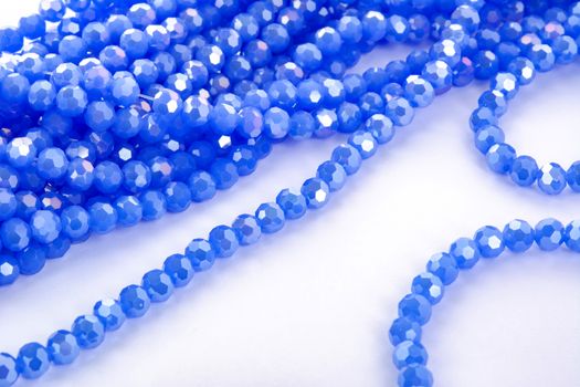 Beautiful blue Glass Sparkle Crystal Isoalted Beads on white background. Use for diy beaded jewelry. Space for text