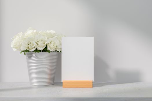 Mockup white greeting card standing on table. Suitable with 5x7 inchs or samilar paper size A4, A5, A6. 3D Rendering.