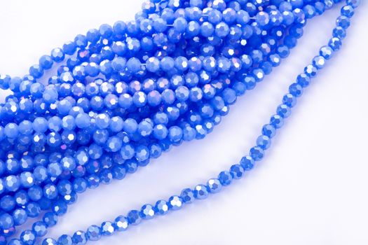 Beautiful blue Glass Sparkle Crystal Isoalted Beads on white background. Use for diy beaded jewelry. Space for text