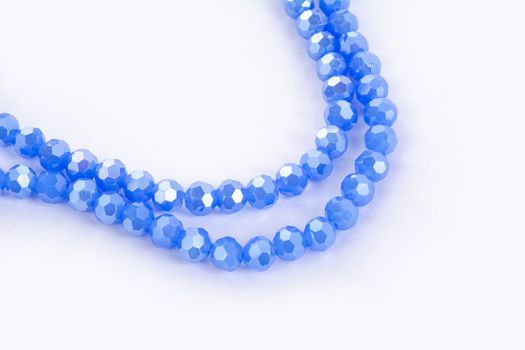Beautiful blue Glass Sparkle Crystal Isoalted Beads on white background. Use for diy beaded jewelry. Space for text