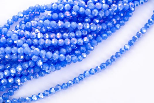 Beautiful blue Glass Sparkle Crystal Isoalted Beads on white background. Use for diy beaded jewelry. Space for text