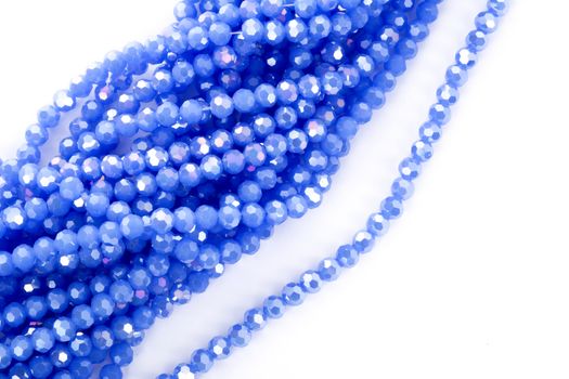 Beautiful blue Glass Sparkle Crystal Isoalted Beads on white background. Use for diy beaded jewelry. Space for text