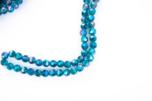 Beautiful emerald Glass Sparkle Crystal Isoalted Beads on white background. Use for diy beaded jewelry. Space for text