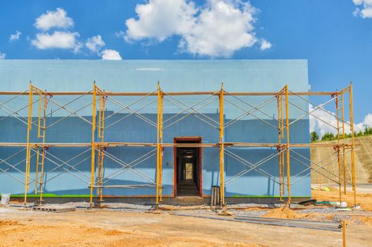 Horizontal shot of a commercial construction project with scaffolding.