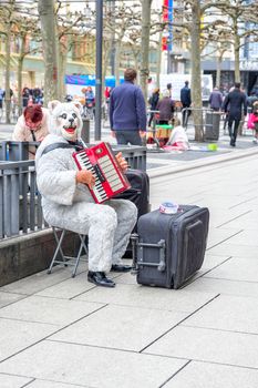 FRANKFRUT, GERMANY- MARCH 26, 2017: Human in Bears suit playing music at Street market on 26 march 2017 in Frankfrut Germany