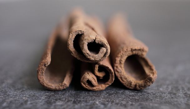 Scented cinnamon sticks on gray concrete countertop. High quality photo