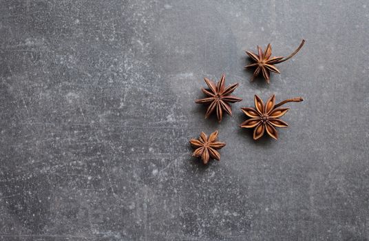 Fragrant star anise stars on a gray concrete countertop. High quality photo