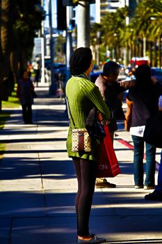Santa Monica,CA/USA - Nov 23,2018 : People are waiting for the bus at the bus stop. Representatives of different nationalities live in United State of America.