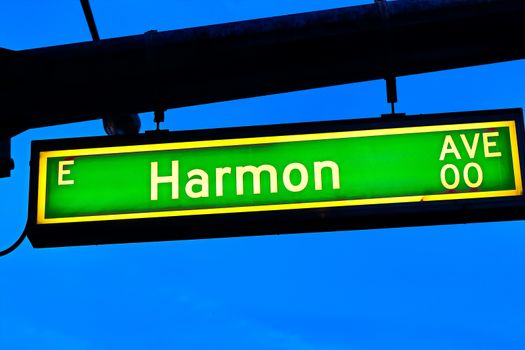 Road sign of Harmon Avenue.Street sign of Harmon Avenue.Green Harmon Avenue Sign with blue sky Background.