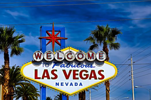 he Welcome to Fabulous Las Vegas sign on bright sunny day in Las Vegas.Welcome to Never Sleep city Las Vegas, Nevada Sign with the heart of Las Vegas scene in the background.