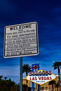 he Welcome to Fabulous Las Vegas sign on bright sunny day in Las Vegas.Welcome to Never Sleep city Las Vegas, Nevada Sign with the heart of Las Vegas scene in the background.