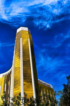 Las Vegas, NV/USA - Sep 15, 2018; Enormous Mandalay Bay Hotel Resort and Casino Las Vegas with beautifully landscaped entrance to modern architectural gold glass facade of building.