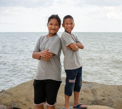 Sister and brother Stand on the sea background