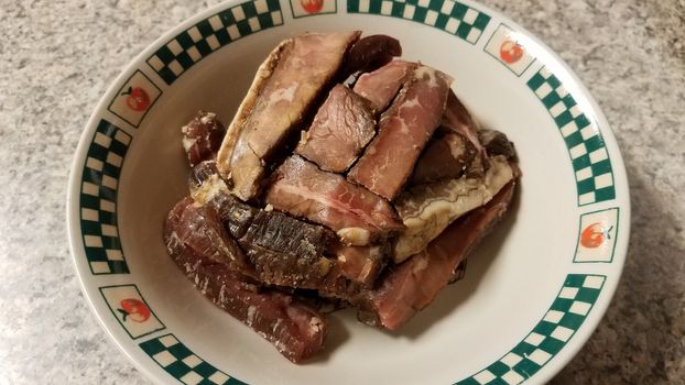 raw beef meat with fat in bowl on counter