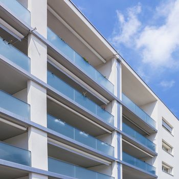 Facade of a modern apartment building on a sunny day with a blue sky. Facade of a new apartment building.