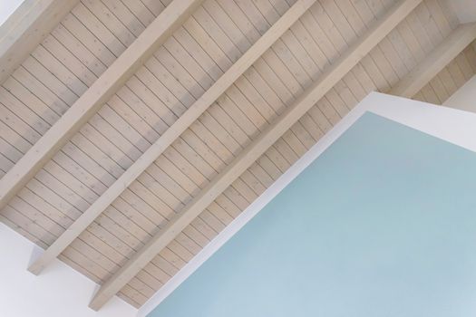 Modern wooden ceiling with exposed beams. Interior wooden roof with exposed beams.