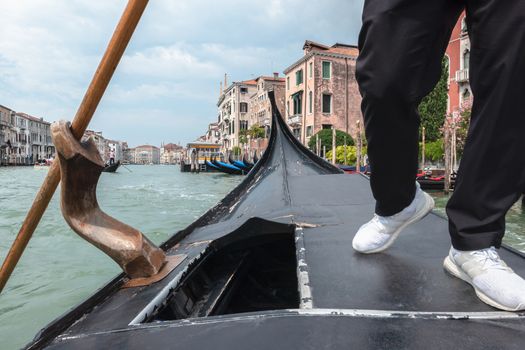 Gondolier navigates on the Grand Canal of Venice, Italy.