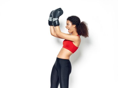 Sporty woman boxing gloves training hitting champion punch