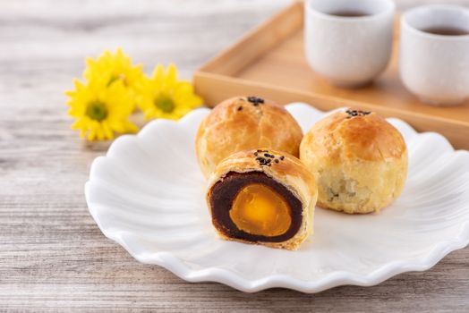 Moon cake yolk pastry, mooncake for Mid-Autumn Festival holiday, top view design concept on bright wooden table with copy space