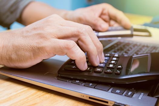 hand of man pays a credit card through an internet online