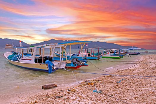 Traditional boats on Gili Meno island in Indonesia at sunset