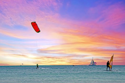 Watersports at Palm Beach on Aruba island in the Caribbean Sea at sunset