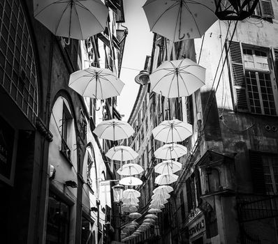 Genova, Italy - 0/29/2020: Multicolored umbrellas against the sky, street decorated. LGBT flag. Rainbow love concept. Human rights and tolerance.