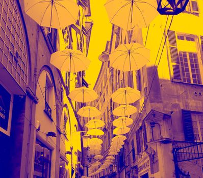 Genova, Italy - 0/29/2020: Multicolored umbrellas against the sky, street decorated. LGBT flag. Rainbow love concept. Human rights and tolerance.