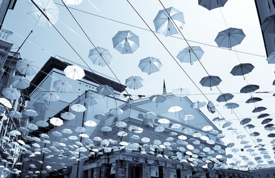 Genova, Italy - 0/29/2020: Multicolored umbrellas against the sky, street decorated. LGBT flag. Rainbow love concept. Human rights and tolerance.