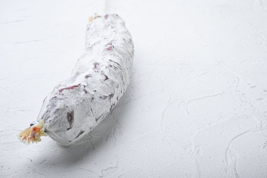 Salami sausage salchichon on white background with space for text.