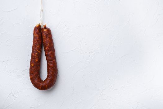 Spanish chorizo sausage on white background with space for text.