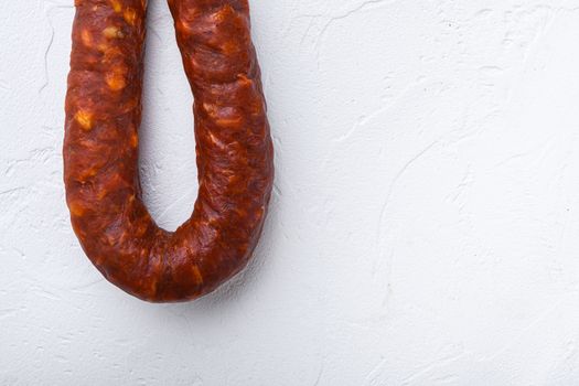 Spanish chorizo sausage on white background with space for text.