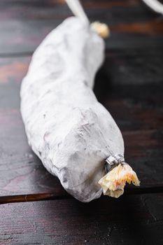 Spanish dry sausages on old wooden table.